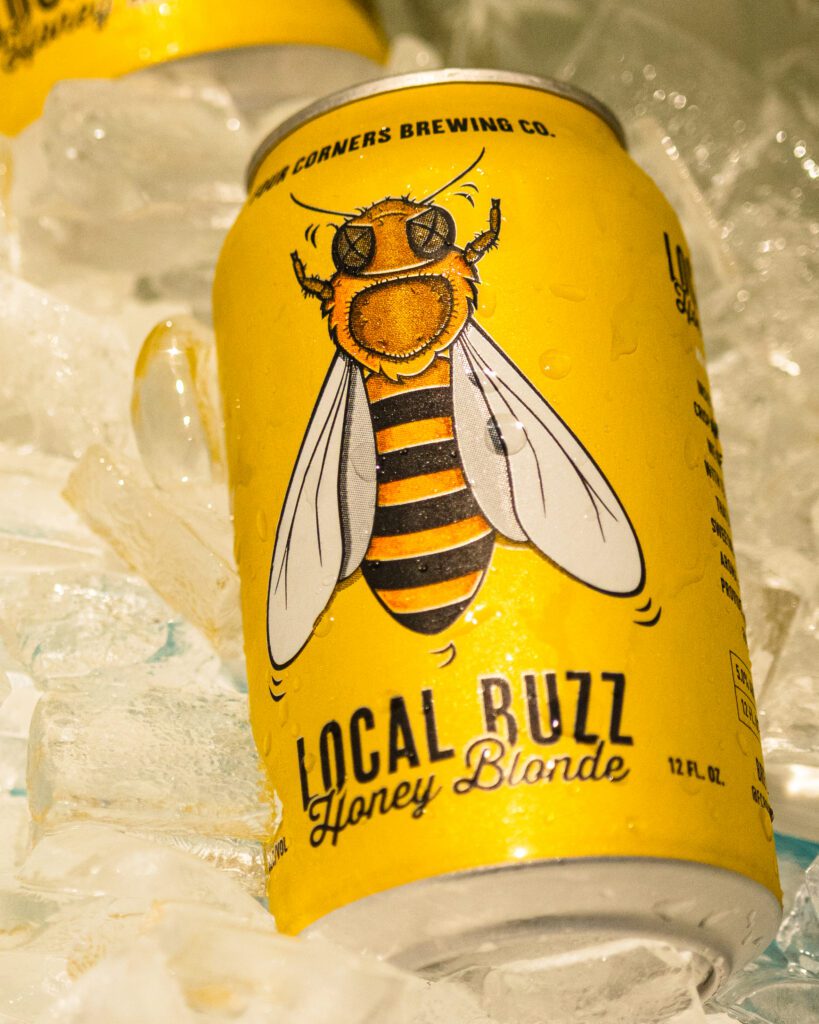 Four Corners Brewing Co. Local Buzz Honey Blonde ale can nestled in ice
